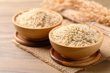 Organic Jasmine brown rice seed in wooden bowl, Thai Rice