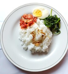 rice with chicken,chilihot chilies, salted fish, boiled eggs, onions, lime, plate