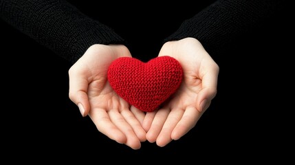 Fototapeta premium Valentine heart idyllic Love concept. Hand holding a knitted red heart symbolizing love and care.