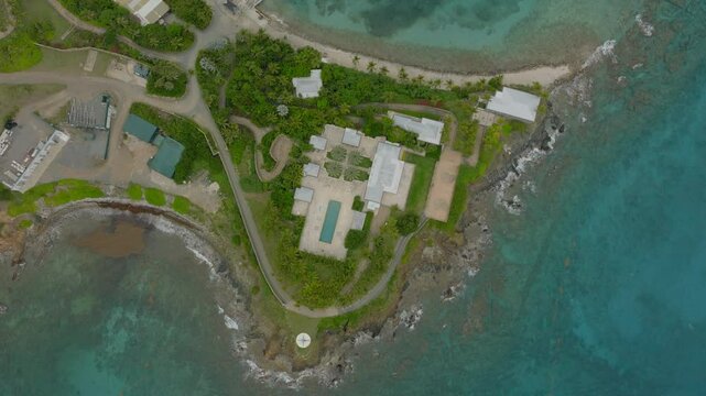 Aerial Top Panning Shot Of Swimming Pool Outside Luxurious House On Small Private Island - VI, 
Little Saint James, United States of America
