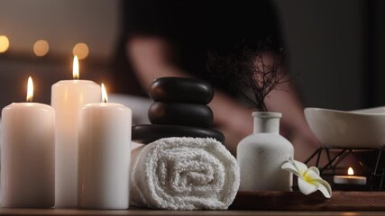 A woman enjoying a hot stone foot massage at a spa, with a professional therapist using stone therapy to relax her feet and enhance comfort. Spa and relaxation concept. - Powered by Adobe