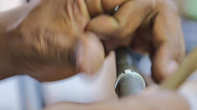 jeweler's hands making unique ring for weddings