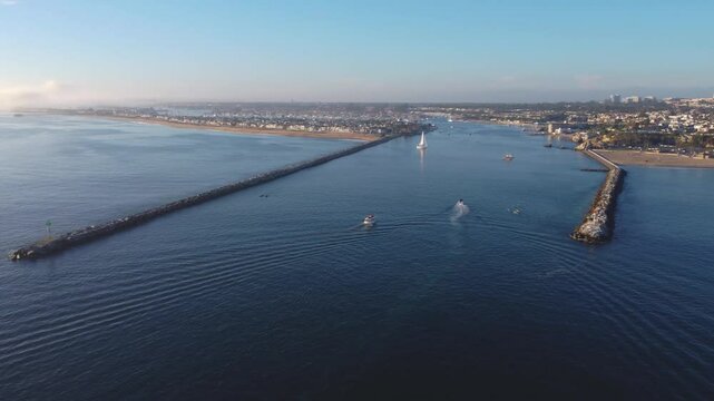 Newport Beach, Pan Past - Jetty Canal, Port Harbor Bay Entrance - to Balboa Peninsula Orange County, Southern California Coast, USA. Corona Del Mar. Mountain View, City Skyline on Hillside.
