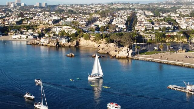 Marine Boat Traffic. Newport Beach, Pan Past - Jetty Canal, Port Harbor Bay Entrance - Orange County, Southern California Coast, USA. Corona Del Mar. City Skyline on Hillside.