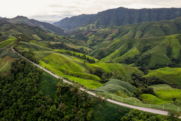 Landscape of Morning Mist with Mountain Layer. mountain ridge and clouds in rural jungle bush forest