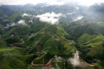 Landscape of Morning Mist with Mountain Layer. mountain ridge and clouds in rural jungle bush forest