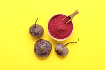 Bowl with beet powder on yellow background
