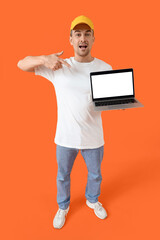 Man with laptop on orange background. Mockup for design