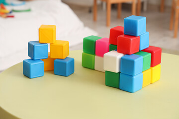 Obraz premium Colorful cubes on table in children's bedroom, closeup