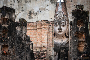 Picturesque view of an iconic huge Buddha statue inside a roofed building of Wat Si Chum temple...