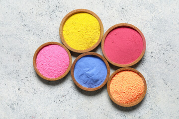 Bowls of powder pigment on grunge background
