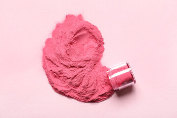Jar of powder pigment on pink background