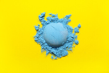 Blue powder pigment on yellow background