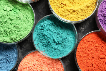 Bowls of powder pigments on grunge background, closeup