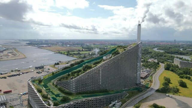 CopenHill in Copenhagen, Denmark, blends a waste-to-energy plant with an urban ski slope, hiking trails, and green spaces, creating a landmark for sustainability and recreational innovation