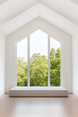 Fototapeta premium Bright modern interior with large windows overlooking green trees in minimalist design