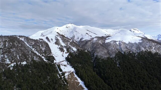 Panorama drone view about the snowy Cerro Bayo Ski Resort with peaky mountains, Argentina.