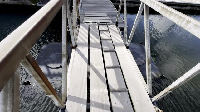 Strolling Along a Modern Marina Dock in Den Helder, Netherlands, Basking in the Warmth of a Sunny Day by the North Sea