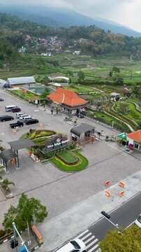 Refugia Garden in Magetan is a beautiful tourist destination featuring vibrant flower arrangements shaped like a butterfly, set amidst lush greenery and offering a picturesque, serene atmosphere.
