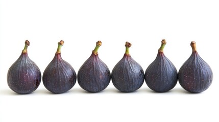 Fototapeta premium Fresh ripe figs arranged in a row showcasing their unique shape and rich coloration against a clean white background for commercial use.