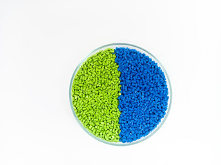 plastic masterbatch, masterbatch granules, polymer carrying pigment poured into a glass cup forming...