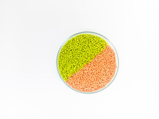 plastic masterbatch, masterbatch granules, polymer carrying pigment poured into a glass cup forming a circle with a white background, as a product catalog design for a plastic industry company profile