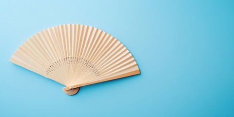 Elegant Bamboo Hand Fan on Light Blue Background Summer Breeze Design