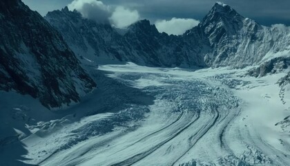 A breathtaking view of a glacier surrounded by towering mountains.