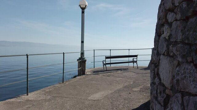 Empty bench revealed on boardwalk Opatia, Croatia