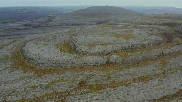 Smooth aerial shot of the Burren mountain summits in slow motion, showcasing their rugged beauty