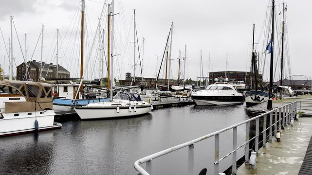 Yachts Huddle Together in a Den Helder Marina, Their Colorful Hulls Reflecting in the Calm Waters on a Cloudy Day Along the North Sea Coast