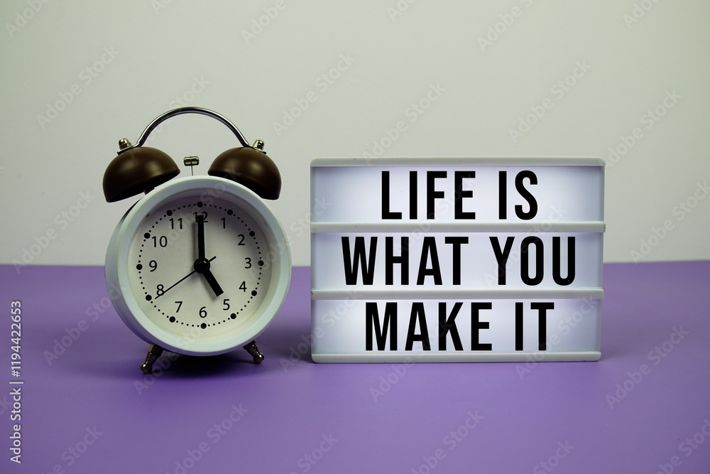 Poster life is what you make it text on light box with alarm clock on purple background