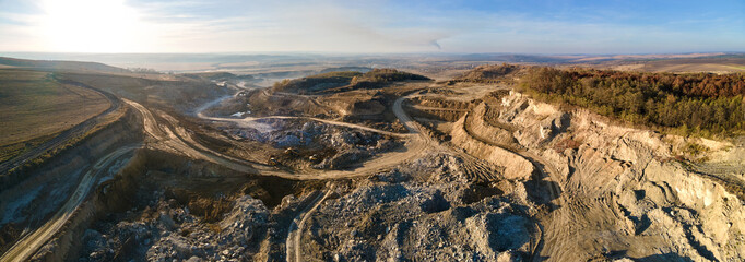 Aerial view of open pit mine of sandstone materials for construction industry with excavators and...