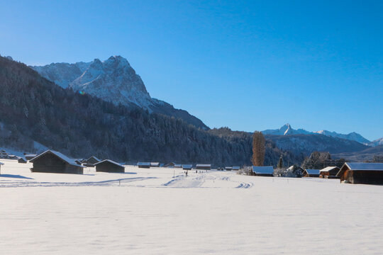 Winter landscape with cabins at the mountain base