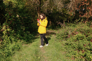 Forest retreat with a thermos and phone in hand