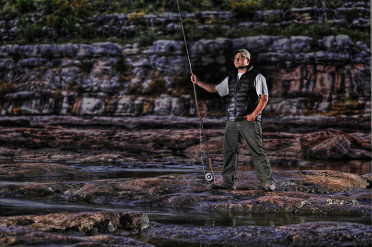 Flyfisherman Colorado riverside with rod in Marble Falls, Texas.