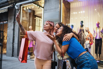 Three young women taking a selfie after shopping spree