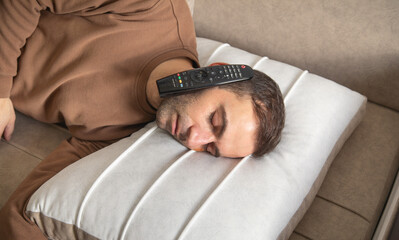 Caucasian man with a Tv controller at home.