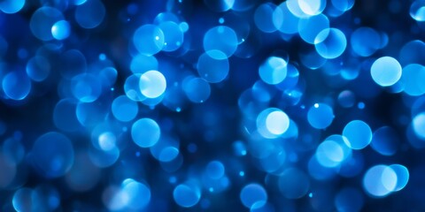 Naklejka premium Abstract bokeh background in blue color creates a mesmerizing visual effect. This blue color abstract bokeh enhances designs with its vibrant hues and can be ideal for various creative projects.