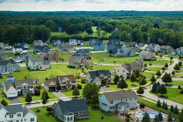 View from above of residential houses in living area in Rochester, NY. American dream homes as...