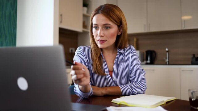 Young woman working online at her home office