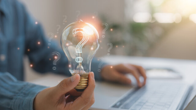 Businessmen holding light bulbs with question mark icon for FAQ. Question mark concept. Problem and solution. Quiz, test, survey, support, knowledge, decision.