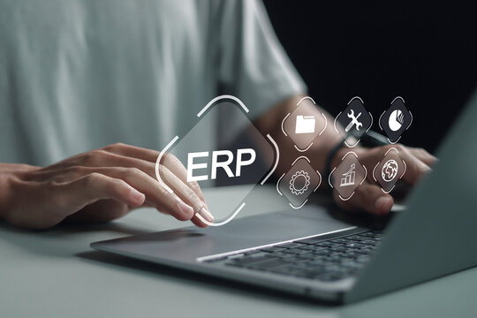 ERP, Enterprise resource planning concept, connections between business intelligence, HR and CRM modules. Person using laptop with document management software on virtual screen.