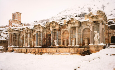 Obraz premium To visit the sprawling ruins of Sagalassos, high amid the jagged peaks of Ak Dag, is to approach myth: the ancient ruined city set in stark . Sagalassos Ancient City under the snow on a winter day.