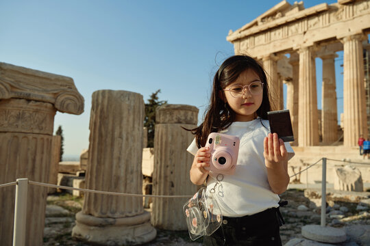 Girl is taking photos of the Parthenon at the Acropolis