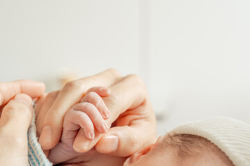 A Newborn Firmly Gripping Its Mother's Finger