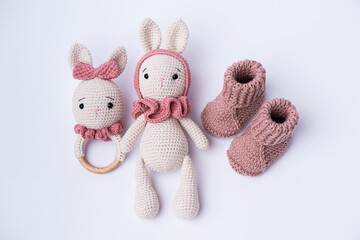 Variety of knitted toys. Bunny and baby booties. Handmade soft toys.