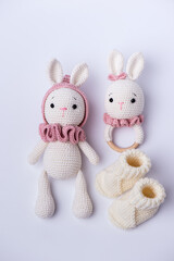 Variety of knitted toys. Bunny and baby booties. Handmade soft toys.
