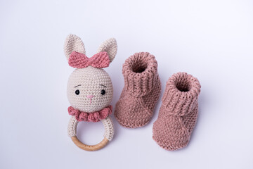 Variety of knitted toys. Bunny and baby booties. Handmade soft toys.