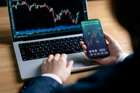 Investors analyze the data stock market index via smartphone screen to trade the stock chart for planning investments take profit, trade stock exchange market and cryptocurrency data, financial.